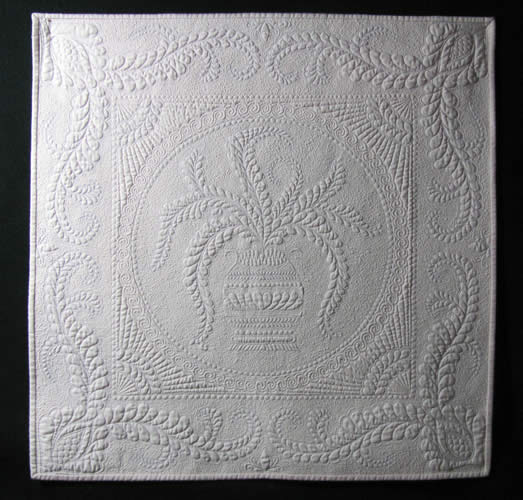 A white quilt illustrating the machine quilting techniques Cindy teaches in her Advanced Machine Quilting workshop