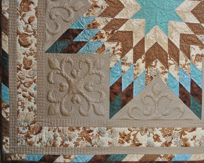 white quilt illustrating the types of machine quilting techniques Cindy teaches in her Trapunto By Machine workshop